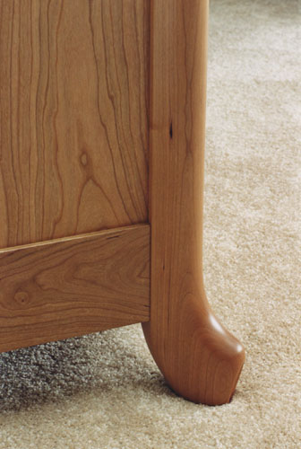 Carved cherry dresser side and leg detail